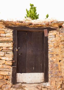 View of old door of rural house in the spanish town