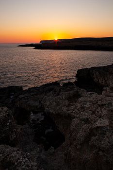 Rock coast of Lampedusa at sunset, Sicily