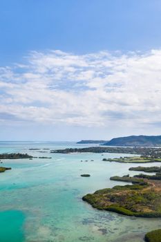 Aerial picture of the east coast of Mauritius Island. Beautiful lagoon of Mauritius Island shot from above. Boat sailing in turquoise lagoon.