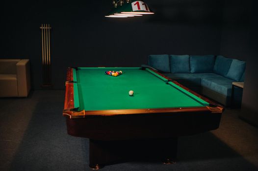Billiard table with green surface and balls in the billiard club.Pool Game.