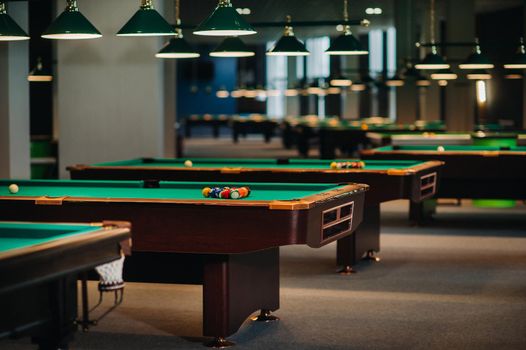 Billiard table with green surface and balls in the billiard club.Pool Game.