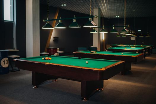 Billiard table with green surface and balls in the billiard club.Pool Game.