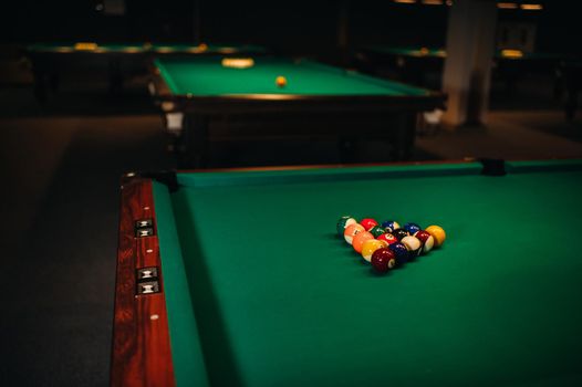 Billiard table with green surface and balls in the billiard club.Pool Game.