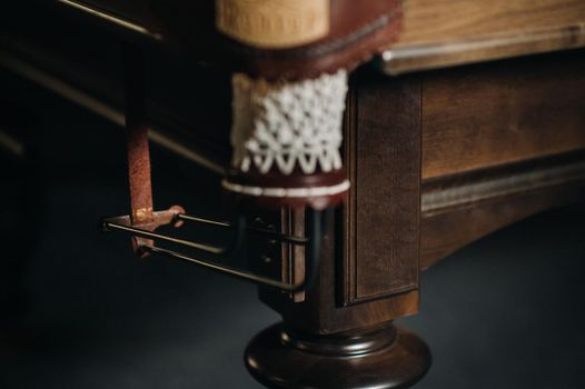 Leather billiard hole and table leg in a billiard club.