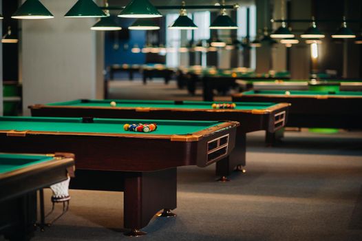 Billiard table with green surface and balls in the billiard club.Pool Game.