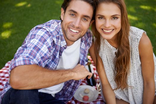 Portrait, picnic and date with a couple in a park together during summer for love, romance or bonding. Face, nature or dating with a young man and woman in a garden for a romantic celebration.