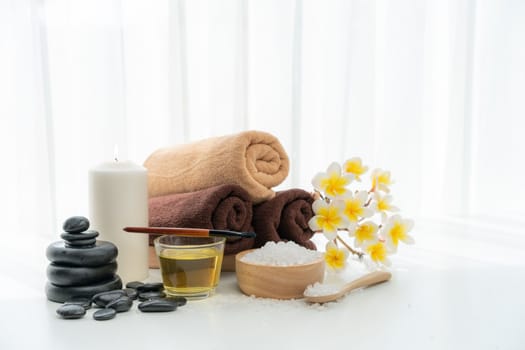 Spa accessory composition set in day spa hotel , beauty wellness center . Spa product are placed in luxury spa resort room , ready for massage therapy from professional service .