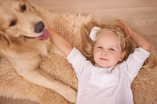 The best friend you can get. An adorable little girl with her dog at home