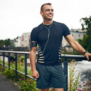 Fitness out in the fresh air. a sporty young man taking a break while exercising outdoors