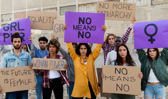 Group of multi-ethnic feminism activist protesting for women empowerment holding banners. No means no movement. Equality concept.