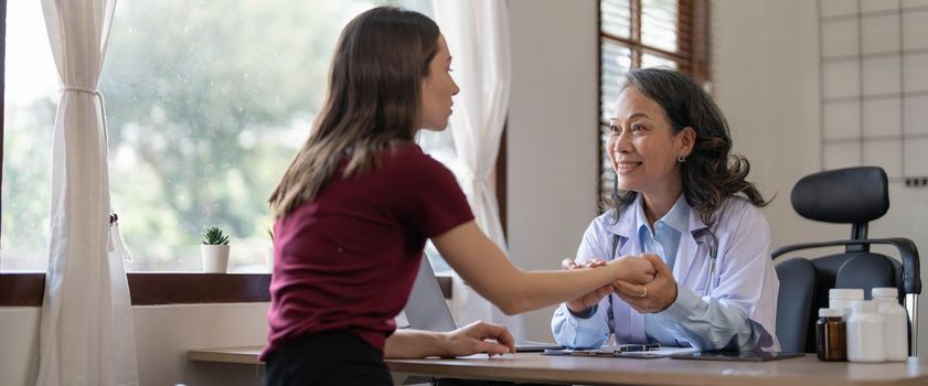 Serious doctor visiting female patient, giving consultation, recommendations, listening to complaints. woman complaining on healthcare problems to physician in white coat..