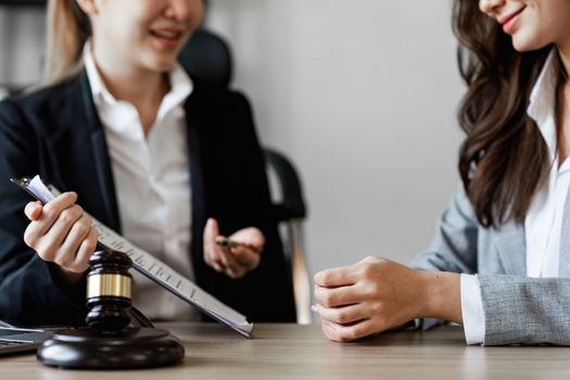 Close up of business person and lawyers discussing agreement contract in office. Law, legal services, advice, Justice concept.