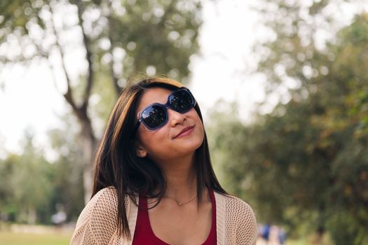 young asian woman with sunglasses smiling playful, concept of youth and beauty, copy space for text