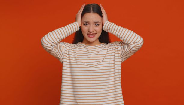 Dont want to hear and listen. Frustrated annoyed irritated one pretty woman covering ears gesturing No, avoiding advice ignoring unpleasant noise loud voices. Young girl on studio red background