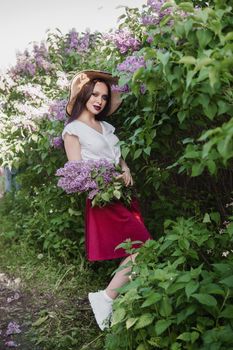 A fashionable girl with dark hair, a spring portrait in lilac tones in summer. Bright professional makeup