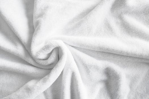 Textured white natural cotton towel background photo with selective focus.