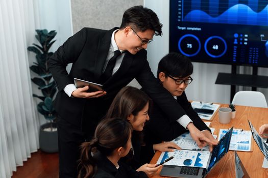 Business team of financial data analysis meeting with business intelligence, report paper and dashboard on laptop for marketing strategy. Business people working together to promote harmony in office.