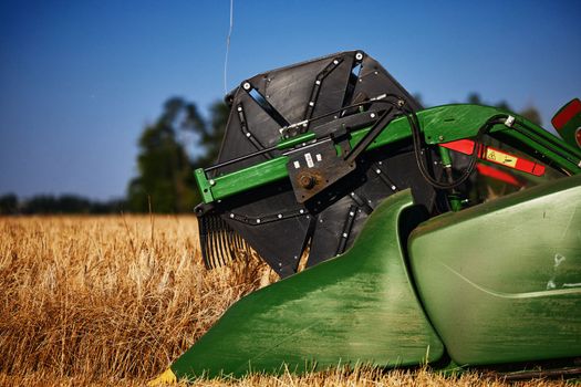 John Deere harvester works in the field. Combine Harvesting Wheat. Field field of cereals during harvesting. Modern equipment works. 07.07.22, Rostov region, Russia.