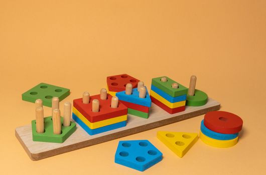 Sorter on neutral background. Multicolored logic sorter close up. Wooden educational logic toy for kid's. Montessori games for early child development