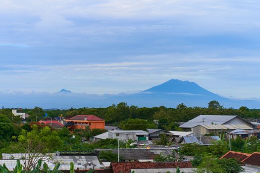 Landscape views of the majestic volcano Agung over the rooftops of the town at its foot.