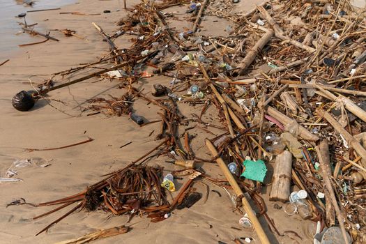 Mountains of waste and garbage on the sandy beach after the tide. Humanity is polluting the ocean. Bali, Indonesia - 11.30.2022