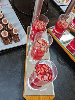 Dessert: delicious cakes on a plate, next to a glass of juice. Top view