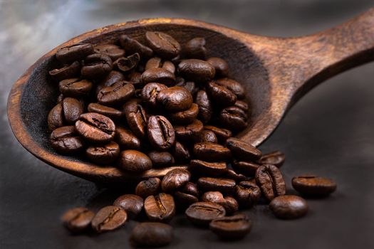 coffee beans with wooden spoon , isolated