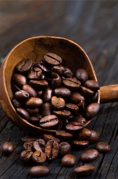 coffee beans with wooden spoon , isolated