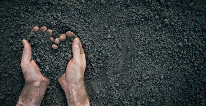 Symbol heart earth day. Handful of dirt hands heart shape. Farmer hands soil ground earth dirt garden soil farm ground. Male hands full of fertile land field agriculture concept. Farm organic earth