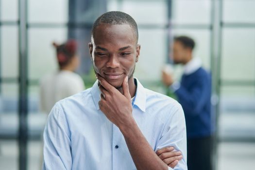 Portrait of a young African American businessman at his workplace waiting for inspiration while