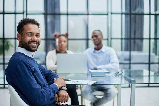 Portrait of African American businessman sitting at desk in an office