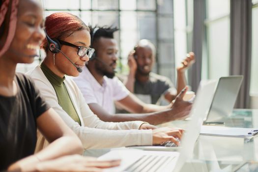 Call Center Operator With Colleagues At Workplace