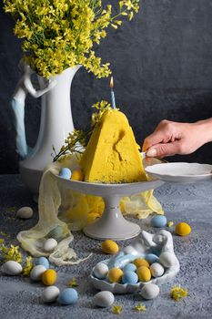 Traditional Easter Orthodox curd cake with yellow flowers on a grey table, High quality photo