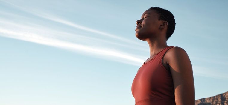 Fitness, breath and mockup with a sports black woman taking a break outdoor against a clear blue sky. Exercise, breathing and motivation with a female athlete or runner outside during summer in space.