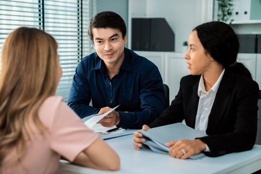 A young female asian candidate tries to impress her interviewer by being competent. International company, multicultural environment in workplace.