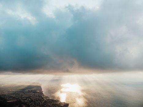 Blue sky with white clouds over calm summer panorama of the sea. Drone aerial view. Abstract aerial nature summer ocean sunset sea and sky background. Horizon. No people. Holiday and vacation concept