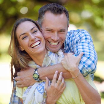 You cant escape my love. Portrait of an affectionate couple outside in the summer sun