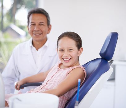 At the dentist for her regular check-up. A young girl at the dentist for a check-up