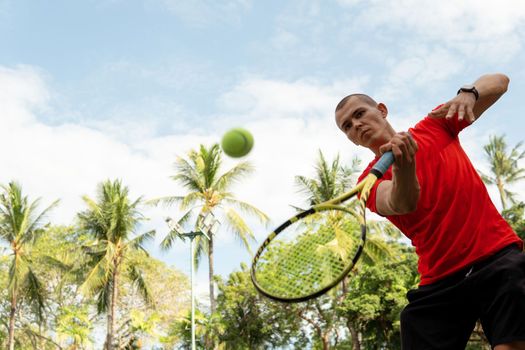 man playing tennis. bali