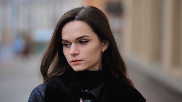 Portrait of a young girl on a city street in early spring