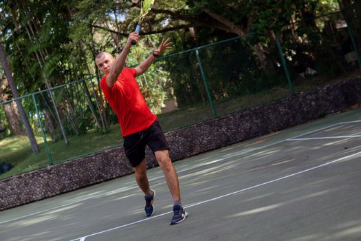 man playing tennis. bali