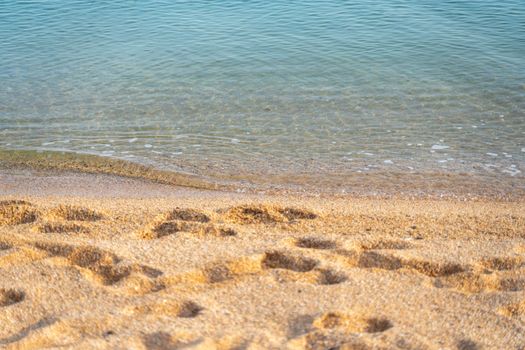 Human footprint on sand summer beach background with copyspace.