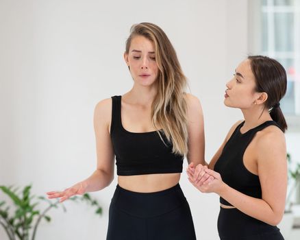 Caucasian woman stands on sadhu boards with therapist support