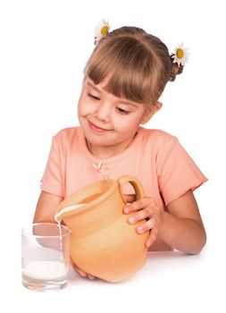 girl pours milk from a jug on a white