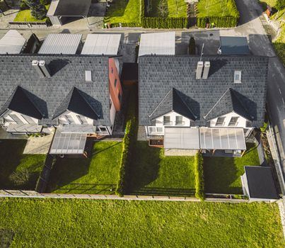 Drone view, aerial shoot of new build houses in the suburbs of Slovenia, somewhere in the country side, Europe. New modern houses, family homes.