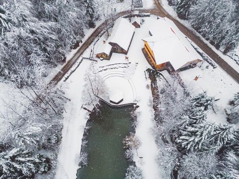 Beautiful winter nature, white snow covering the land, trees covered in snow, branches cracking under the weight. Frozen winter lake, beautiful winter scenery.