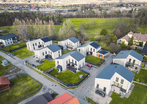 Drone view, aerial shoot of new build houses in the suburbs of Slovenia, somewhere in the country side, Europe. New modern houses, family homes.