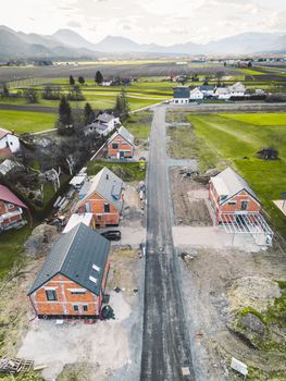 Drone view, aerial shoot of new build houses in the suburbs of Slovenia, somewhere in the country side, Europe. New modern houses, family homes.