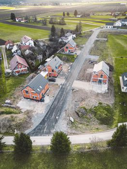 Drone view, aerial shoot of new build houses in the suburbs of Slovenia, somewhere in the country side, Europe. New modern houses, family homes.