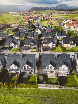 Drone view, aerial shoot of new build houses in the suburbs of Slovenia, somewhere in the country side, Europe. New modern houses, family homes.